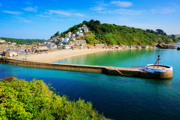 istock Looe Cornwall harbour wall with beautiful blue sea and sky south west UK 1358082668