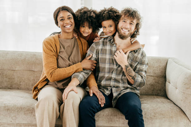 istock Happy kids with smiling parents at home 1358084194