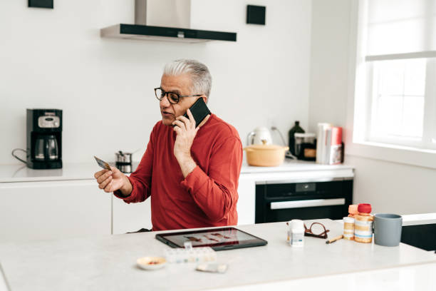 istock Online shopping. Senior man using a credit card 1358084228