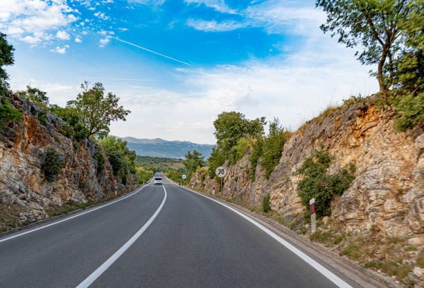 istock Scenic road. Road is surrounded by a magnificent natural landscape. 1358084591