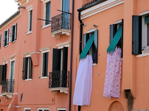 Typical house façade in Italy with laundry
