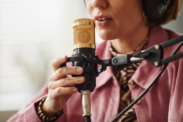 istock Woman Speaking to Microphone Close Up 1358087441