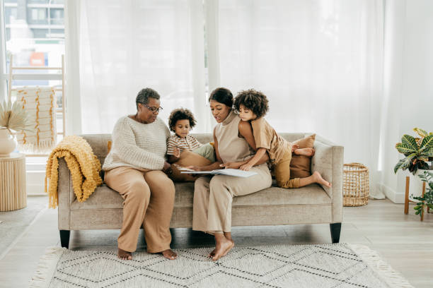 istock Grandmother reading a book for grandkids 1358087635