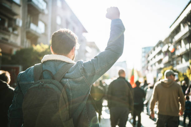 istock Young Man Protester Raising His Fist Up 1358090614