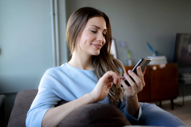 istock Happy Caucasian woman using a smart phone at home 1358090690