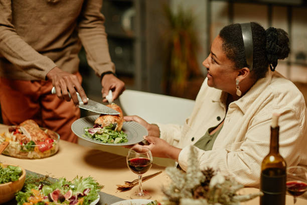 istock Family Serving Chicken at Dinner 1358090839
