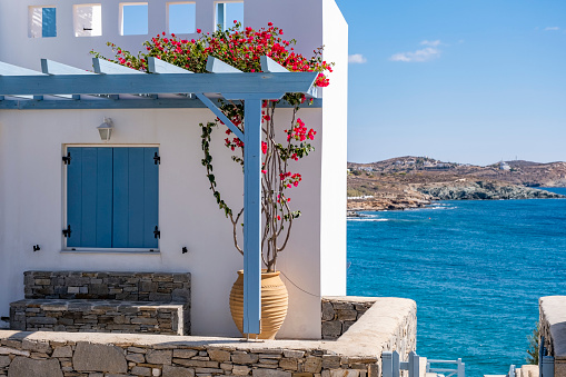 Cute house at the sea with bougainvillea at entrance on Syros Island.