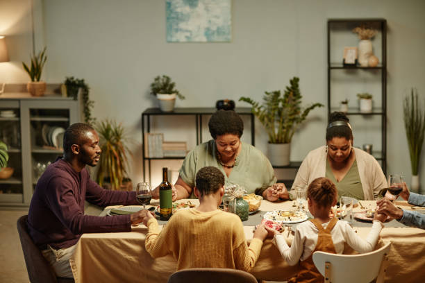 istock Big Family Saying Grace at Dinner 1358090853