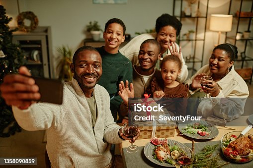 istock African American Family Taking Selfie at Christmas 1358090859
