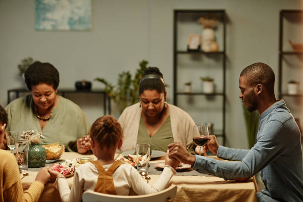 istock Black Family Saying Grace at Dinner 1358090863
