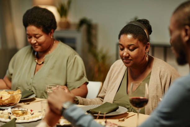 istock Family Saying Grace at Dinner 1358090867