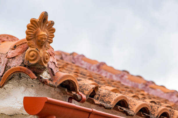 istock Closeup on ceramic antefix decorative pottery ornament on rooftop 1358090940