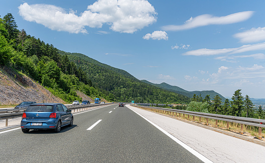Plitvice, Croatia - July 31, 2021: Volkswagen Polo and other cars drive along the highway in Plitvice, Croatia.