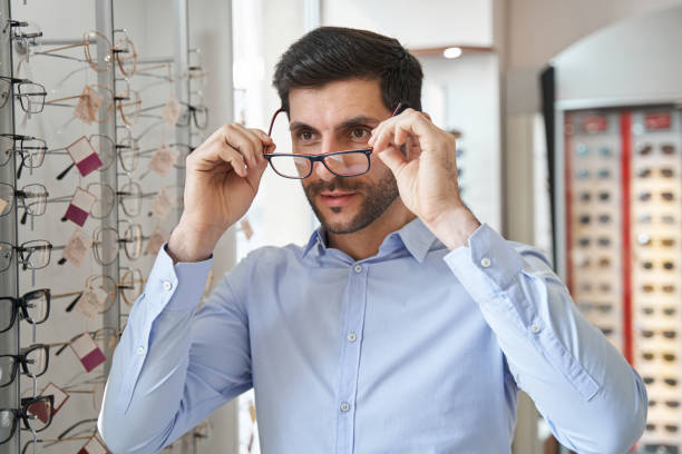 istock Male fitting glasses on his eye in optics store 1358091380