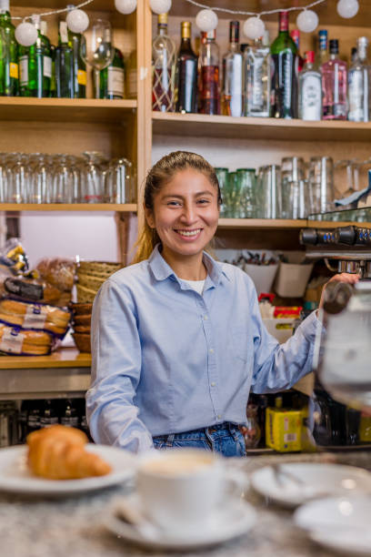 young Peruvian small business bistro prepare a breakfast with croissants and coffee stock photo