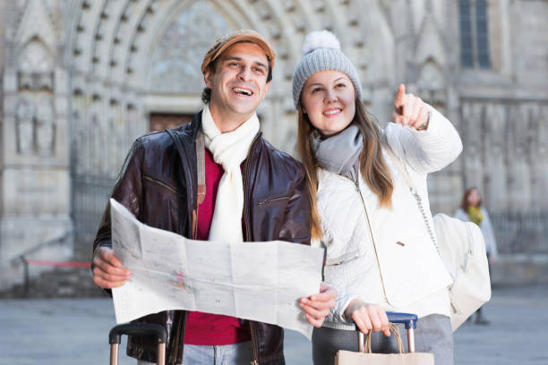 istock Smiling couple man and woman with map 1358093278