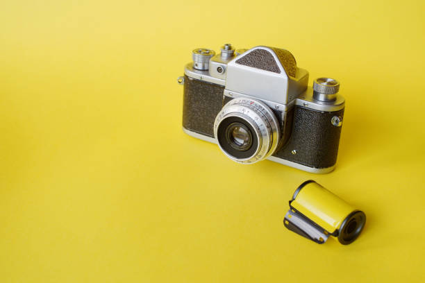 istock Vintage Film Camera On Yellow 1358094614