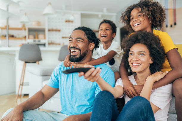 istock Family watching television 1358094973