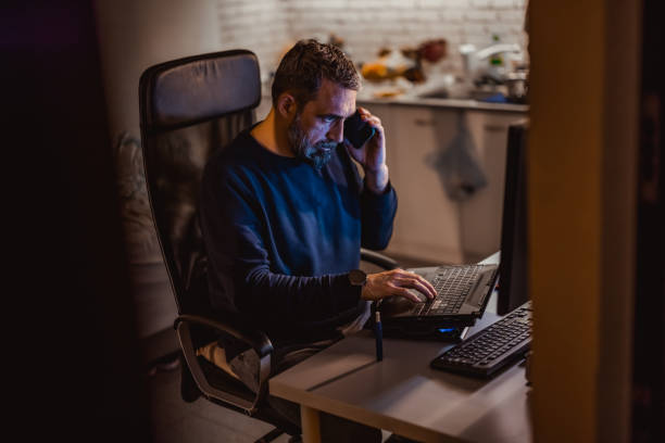 istock Handsome mature man  Specialist Working on Desktop Computer in Creative Home Living Room. 1358096097