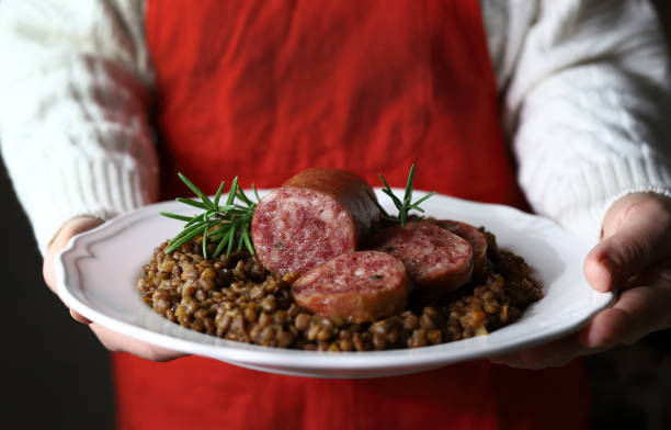 Italian large pork sausage cotechino and lentils. stock photo