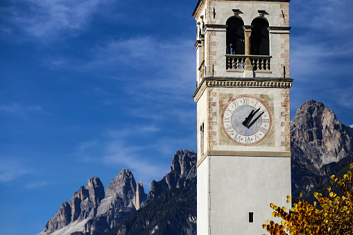 Church tower in town Auronzo di Cadore in Dolomiti mountains, part of European Alps in Italy.