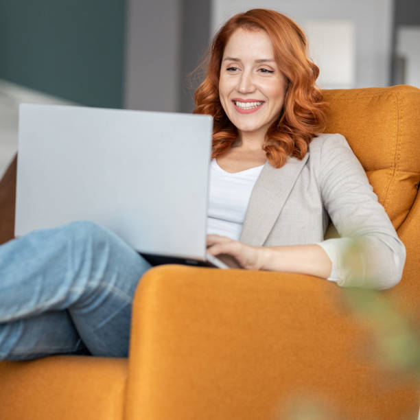 Working from the comfort of living room stock photo