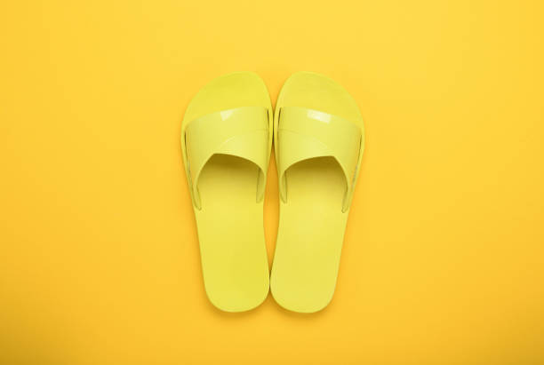 istock Yellow slippers on a yellow background. 1358098431