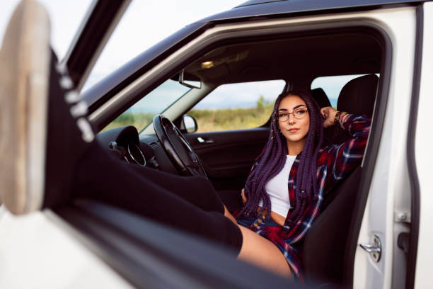 istock Modern Caucasian young woman taking a break from car ride 1358098495