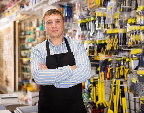 istock Man seller in apron having tools in hands 1358098593