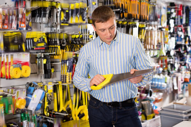 istock Male customer choose bucksaw at hardware store 1358098603