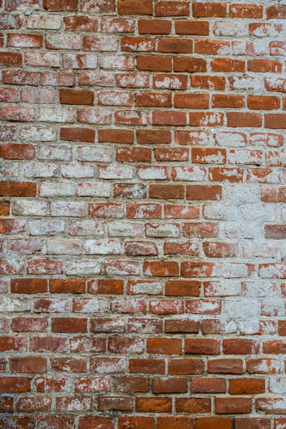 istock Background of old vintage dirty brick wall with peeling plaster, texture 1358098803