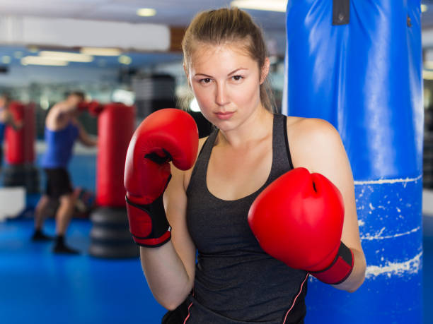 istock Woman boxing in gym 1358098813