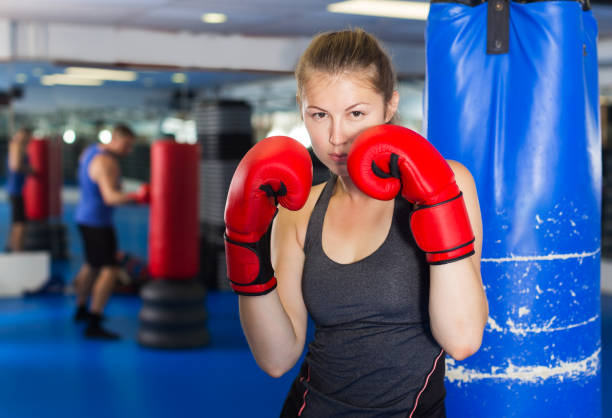 istock Woman boxing in gym 1358098825