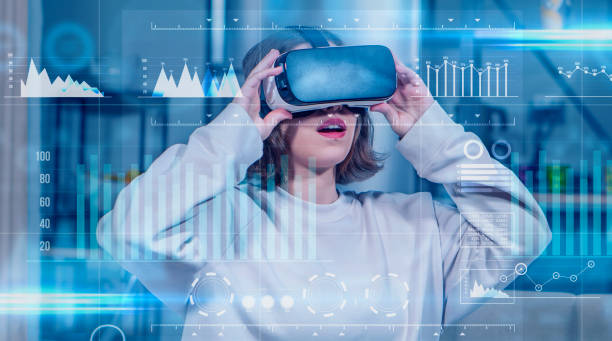 istock Amazed young girl gesturing and smiling cheerfully while wearing a VR headset indoors. 1358099193