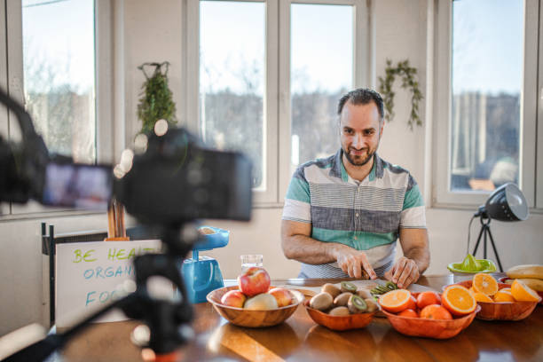 istock Young doctor making a video about importance of implementing fruit in everyday diet 1358101011