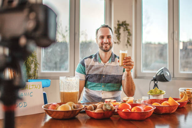 istock Young doctor making a video about importance of implementing fruit in everyday diet 1358101097