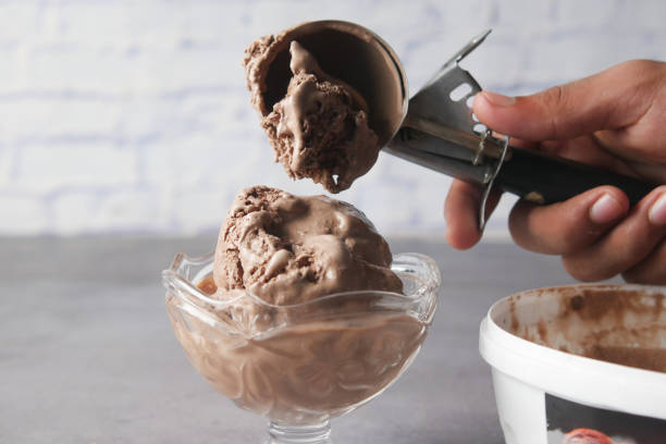 istock hand picking ice cream with a spoon from a bowl 1358101151