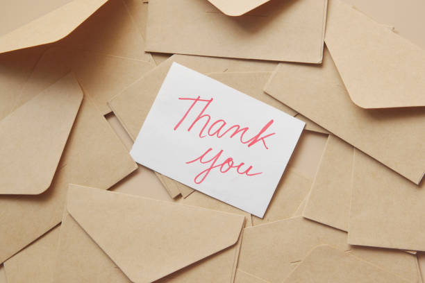 istock thank you message and envelope on wooden table 1358102499