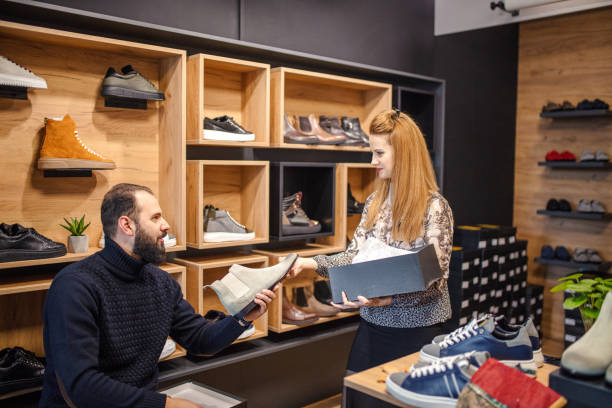istock Young man choosing shoes in a store 1358106551