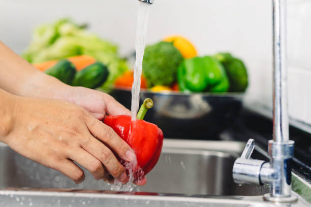istock Hands wash vegetables in the kitchen. 1358107591
