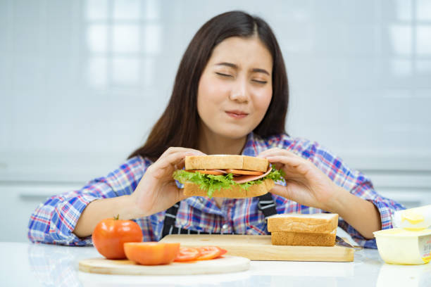 istock asian woman happy make sandwich. 1358108091
