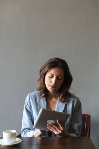 istock Amazing woman sitting indoors using tablet computer. 1358109218