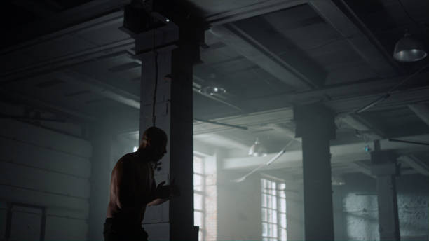 istock Kickboxer training in loft building. Athlete preparing for fight competition 1358109289