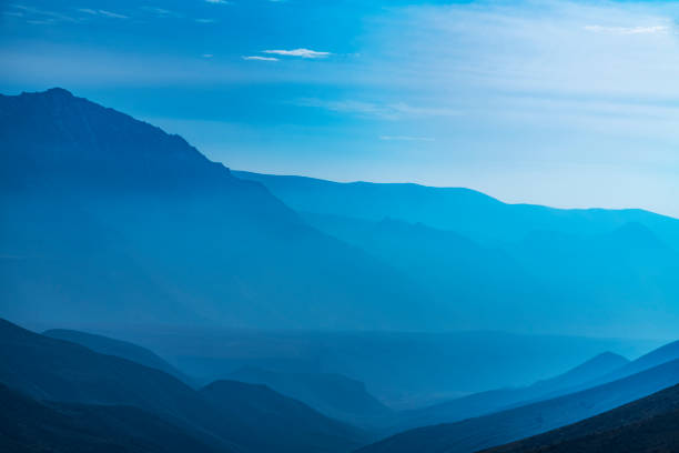 istock Panoramic view on the mountains and hills with clouds and fog 1358109456