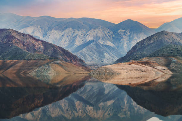 Beautiful sunset on the and mountains with reflection in the water.