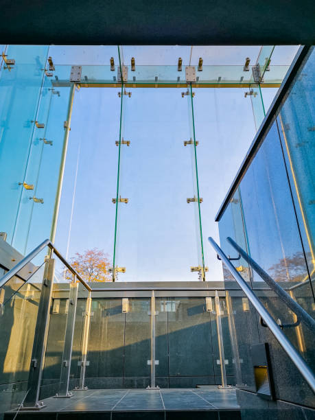istock Looking up to glassy staircase to underground parking 1358110488