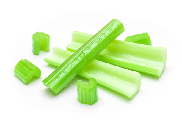 istock Fresh Chopped Celery Sticks and Slices with Water Drops Isolated on White Background 1358113410