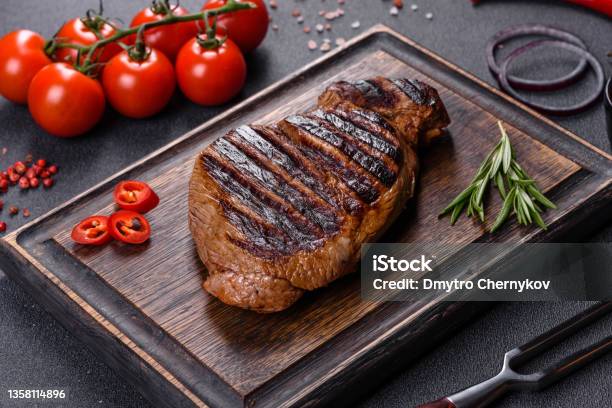 Cooked Grilled Chuck Eye Roll Steak On A Chopping Board Stock Photo - Download Image Now