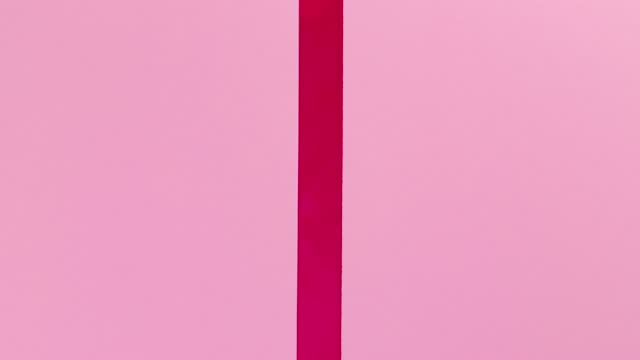Unwrapping gift for saint Valentine's Day revealing a green screen - Stop Motion Animation - Pink bow on pink wrapping paper