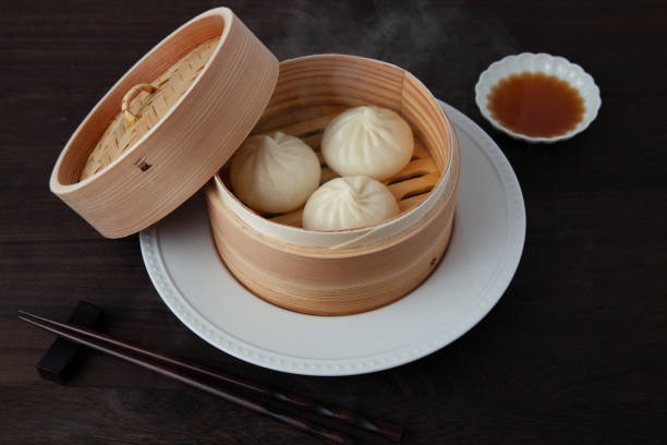 istock xiaolongbao Chinese steamed bun mantou dumpling on wooden table 1358117735
